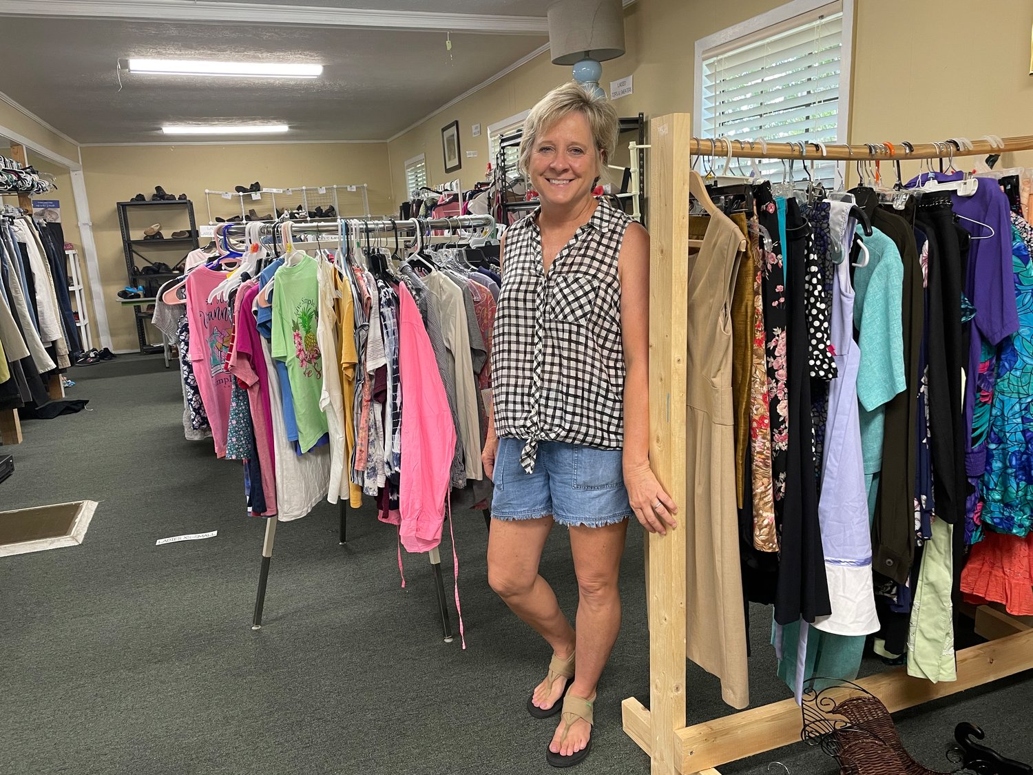 Volunteer Christy Street in front of rows of clothes at the Resource Center located at Trace Ridge Church. The center first opened in 2018 and continues to grow each year. To date, the center has given away over 1,000 food packages, 200 beds, and around 200 sets of bedding to needy people in the community.