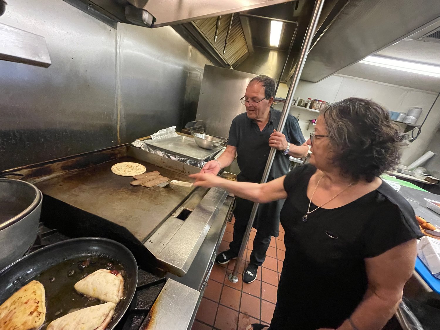Stefano Mangafakis,left, helps his wife Despina Mangafakis, right, grill some beef for gyros. Their Ridgeland restaurant, YiaYia’s Greek Kitchen, was recently honored with a culinary award from the country of Greece for their authenic foods.
